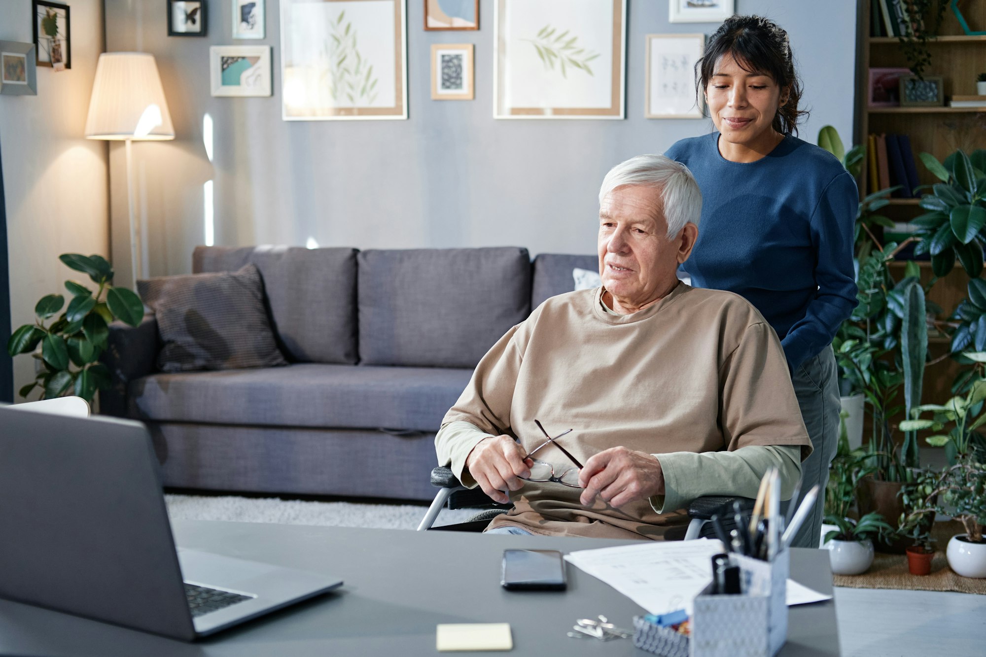 Woman helping senior man at home