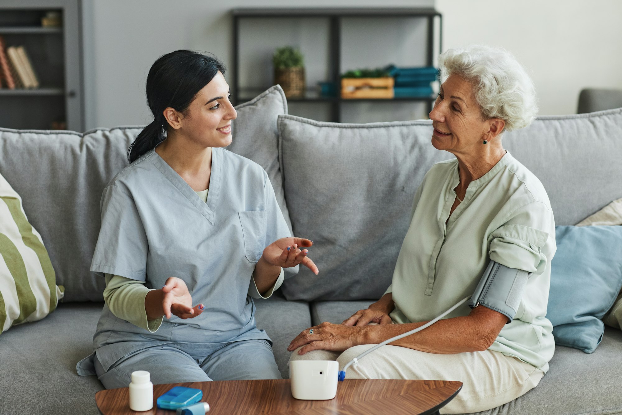 Young Nurse Talking to Senior Woman in Retirement Home